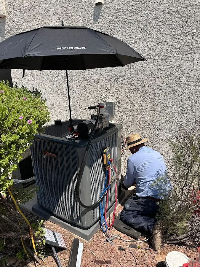 HVAC technician performing outdoor AC maintenance in Redland